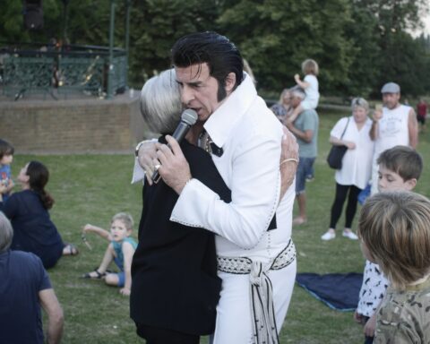 woman hugging man holding microphone