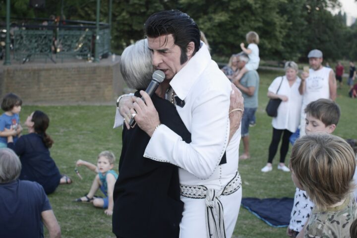 woman hugging man holding microphone